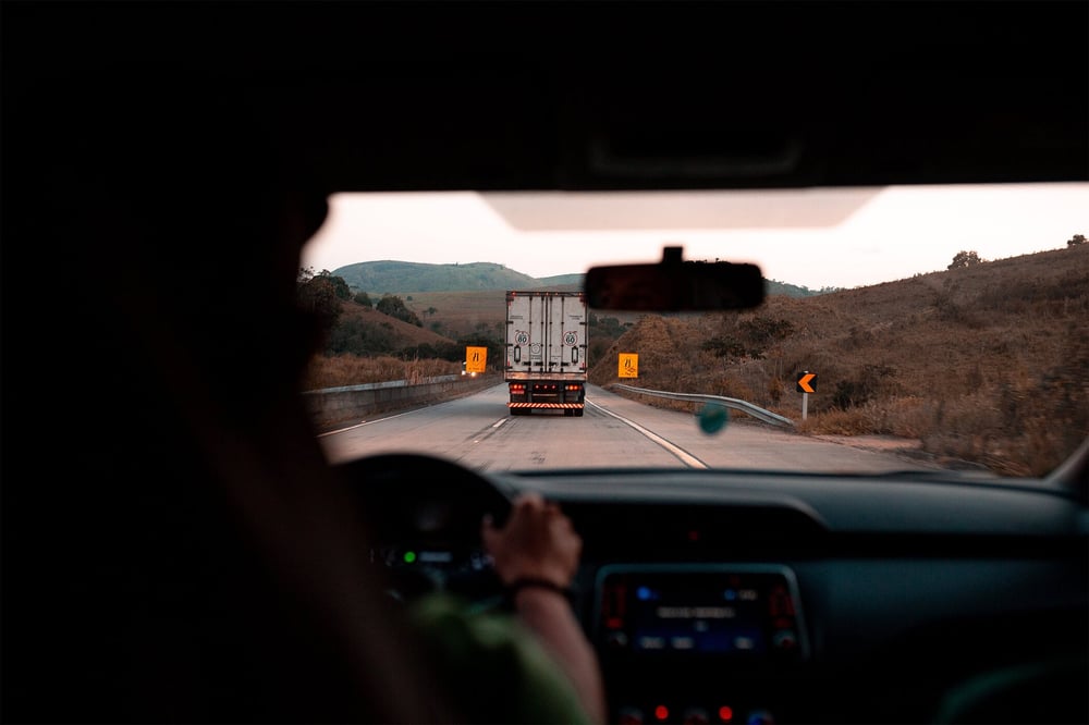 POV driver, following a truck through rural area