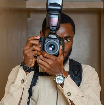 man holding camera pexels-2